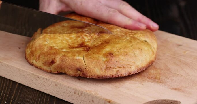 Cut oriental flatbread made of wheat flour with water and spices, parts of oriental fresh flatbread on the table