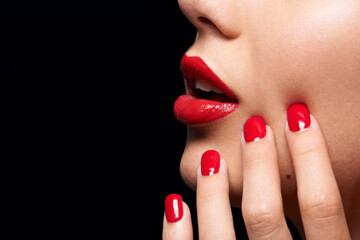 A splash of COLOR. A cropped studio shot of a beautiful model wearing red lipstick and nailpolish.