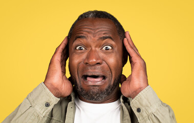 Headshot shocked frightened adult black guy with open mouth afraid and screaming