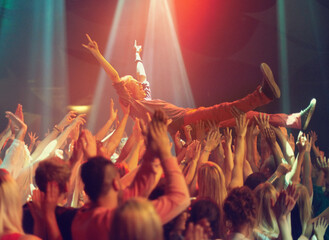 A young man crowd surfing to his favorite band. This concert was created for the sole purpose of this photo shoot, featuring 300 models and 3 live bands. All people in this shoot are model released.