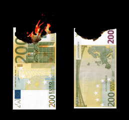 Burning money. Conceptual idea of ​​wasting or losing money on wrong trade. 200 euro burned. Europe euro.