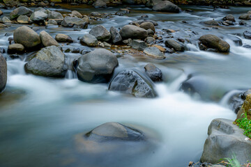 Fototapeta premium River water flow photographed with long exposure technique so it looks smooth like silk