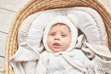 Baby lying in wicker cradle. Happy Mother's and Father's Day. Childhood and parenthood