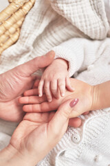 Сhild's palm in parents hands. Happy Mother's and Father's Day. Childhood and parenthood