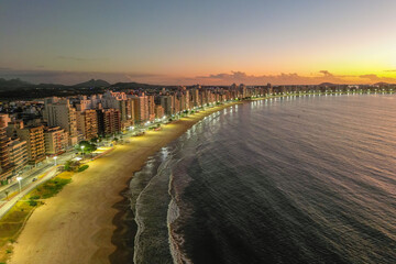 Imagem aérea do nascer do sol na Praia do Morro. Alvorecer avermelhado na cidade de Guarapari no...