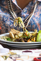 Fototapeta na wymiar Colombian gourmet food plate on elderly woman's table