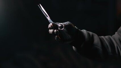 Barbershop man professional barber glove playing hairdresser scissors closeup isolated on black