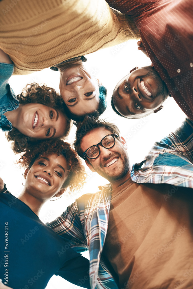 Poster we share a great team dynamic. portrait of a group of designers standing together in a huddle.