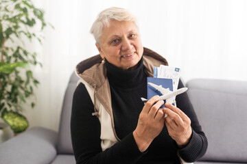 old woman with tickets and a toy airplane