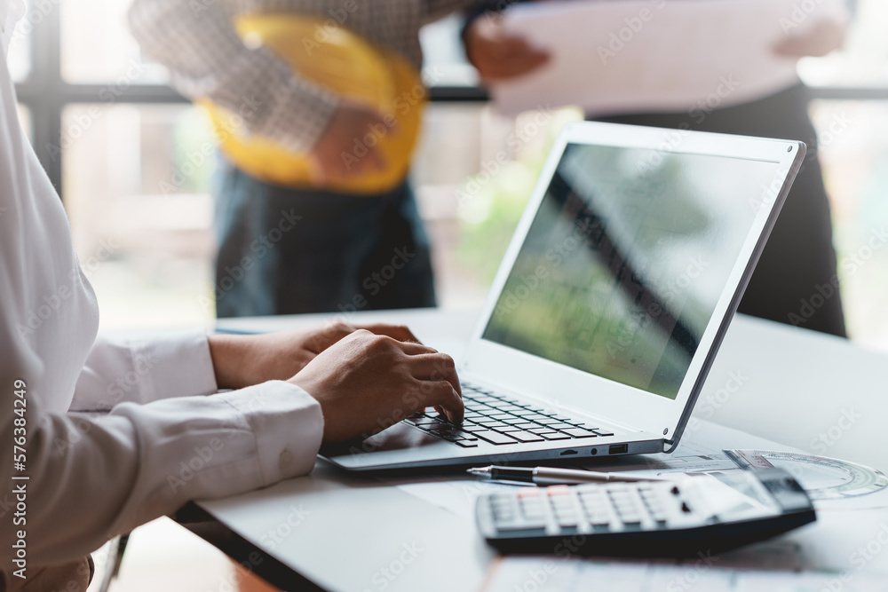 Poster businesswoman working using laptop computer to record and type data.