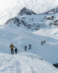 group of mountaineers doing a route with snowshoes in winter on a sunny day in the pyrenees