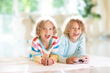 Obraz na płótnie Canvas Kids play video game. Children with controller.