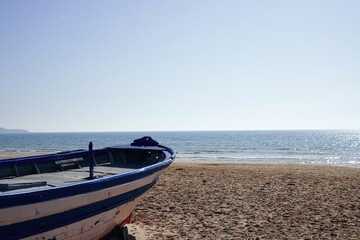 Mediterranean sandy beach with old boat  background