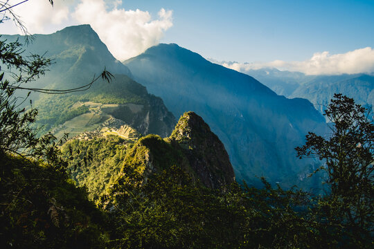 Aerial  above Machu Picchu Valley, Inca Trail, Terraces, Temple, Peru with Andean Cordillera Shining in the Background, UNESCO Protected Site