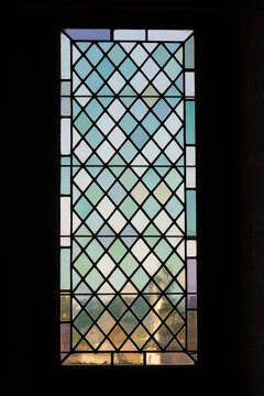 Antique multicolored medieval stained glass window panel in  Avignon, France