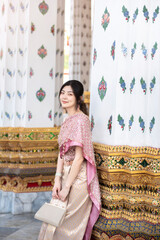 Beautiful Asian girl in Thai traditional costume at temple