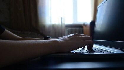 side view hands typing on a laptop, a person writing an email, working from home, working on the...