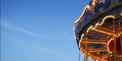 bright background, banner sky and carousel, amusement park, glowing carousel © Svetlana Leuto