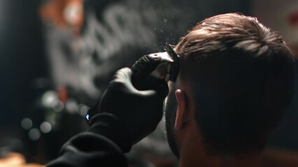 Barbershop male barber hands shaving customer hairs electric trimmer machine closeup slow motion