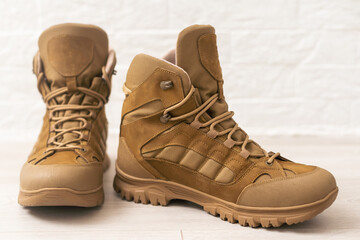 old brown military boots on a wooden table.