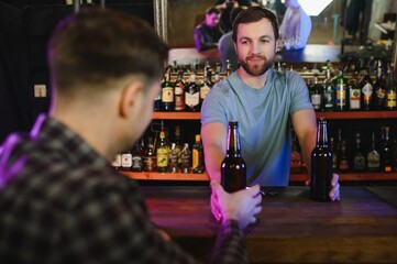 Portrait Of Smiling Male Bar Owner Standing Behind Counter