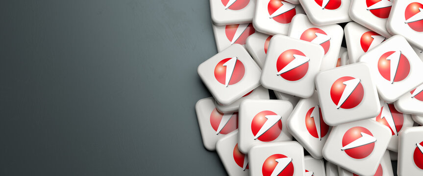 Logos of the German bank Hypovereinsbank and Italian Unicredit on a heap on a table. Copy space. Web banner format.