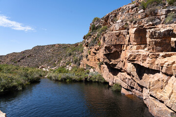 Fototapeta na wymiar River running through a rocky desert landscape in south africa 