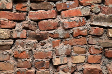Weathered stained old brick wall .