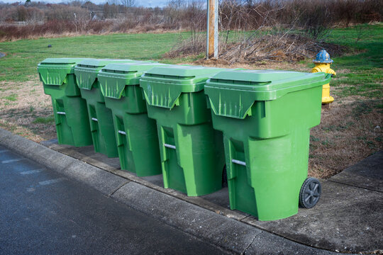 Row of Trash Cans On Dump Truck Day