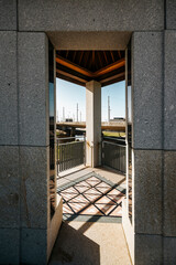 Vertical shot of stone and wood gazebo entrance, lines and shapes with sunlight, in Porto park, Portugal