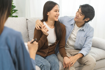 Psychology, depression asian young couple love, patient consulting problem mental health with psychologist, psychiatrist at clinic together, husband embracing shoulder of wife, therapy health care.