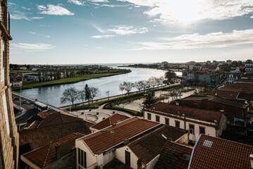 View of the roofs of the traditional houses of Vila do Conde, the Ave River and blue sky - Portugal