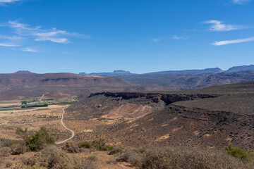 Fototapeta na wymiar landscape photo of a road meandering through the Karoo in South Africa 