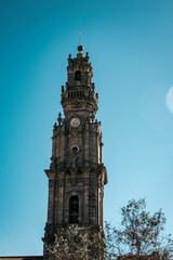 Torre dos Clerigos highlighted in the blue sky. flare. Porto, Portugal