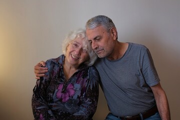 Happy senior adult mature couple hugging.
