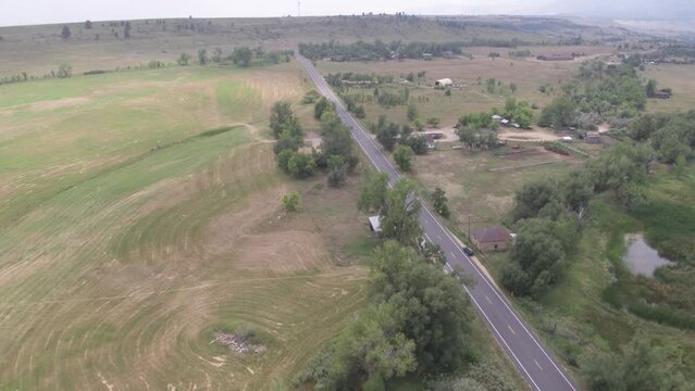 Aerial above rural mountain homes in countryside in Boulder Colorado