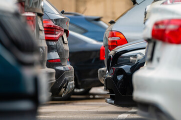 Tight Car Parking Space in the Middle of the City. Lot of cars are parked in the parking lot.