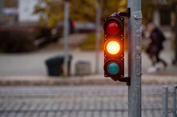 traffic light on the street junction with beautiful bokeh, city with cars in the background