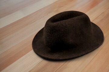 Modern stylish hat on wooden background