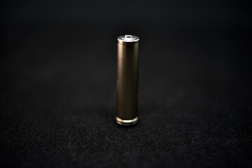 A shiny electric battery on a black background. The battery is a close-up.