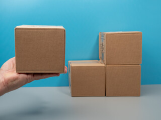 Humanitarian aid. Cardboard boxes with donations on a blue background. Close-up.
