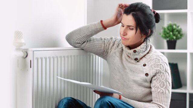 Shocked European woman received home heating paying bill invoice with increase price budget expenses