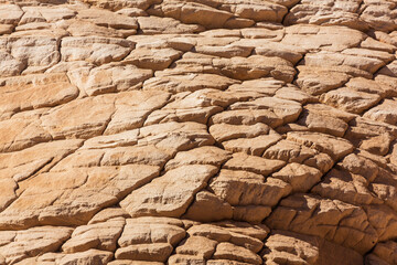 Texture and pattern of rocks in White Canyon in Sinai. Yellow and orange sandstone textured carved mountain, bright blue sky. Egyptian desert landscape. Background. Sinai peninsula, Egypt