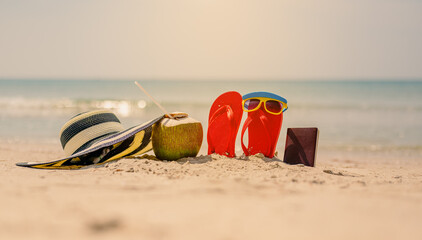 Women yellow sunglasses and red flip-flops,hat beach and coconut on sandy.Travel by sea. Beach...