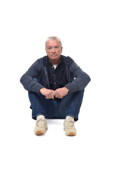 Front View Of A Man Sitting On The Floor With Legs Folded And Serious And Looking At Camera On White Background