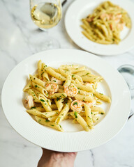 Pasta with shrimps, garlic, lemon and parsley. Penne with shelled shrimps