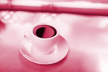 Cup of black coffee in Viva Magenta modern color