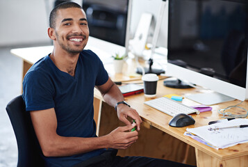 Make creativity a job. Portrait of a young designer at work on his computer.