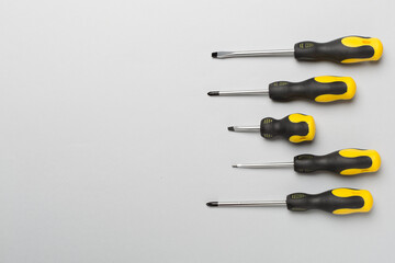 Screwdrivers on color background, top view