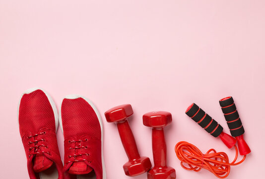 Red sport equipment on color background, top view © Liami
